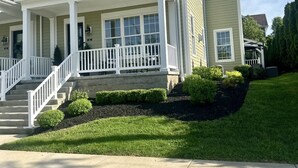 A two-story house with a front porch, a staircase, and a well-maintained lawn. - The Sand Trap 3 bed 3 bath new development walkable to Oakmont country club (Oakmont)