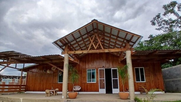 A wooden building with a covered porch and a door. - Punta Paraíso Oaxaca (Oaxaca)