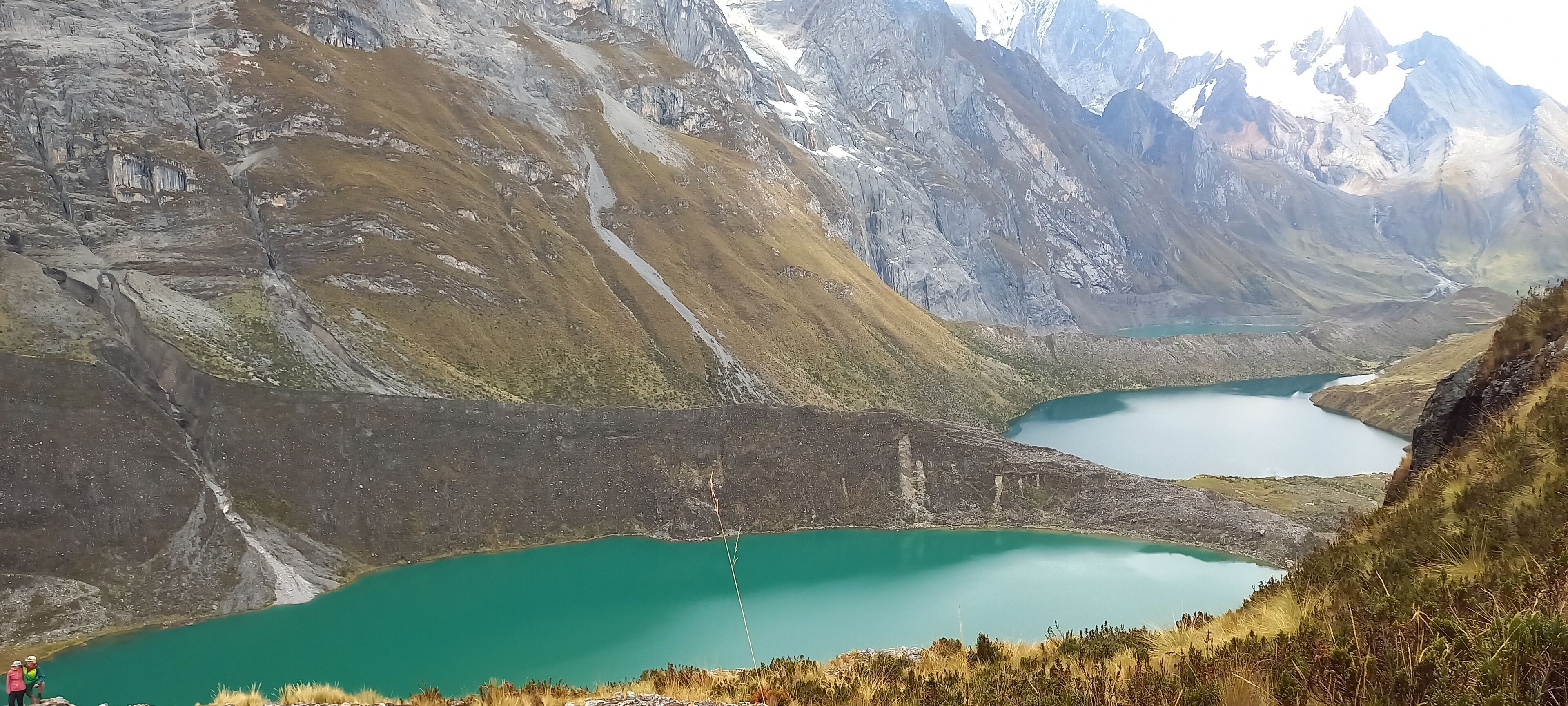 A mountainous landscape with two turquoise lakes and a rocky terrain.