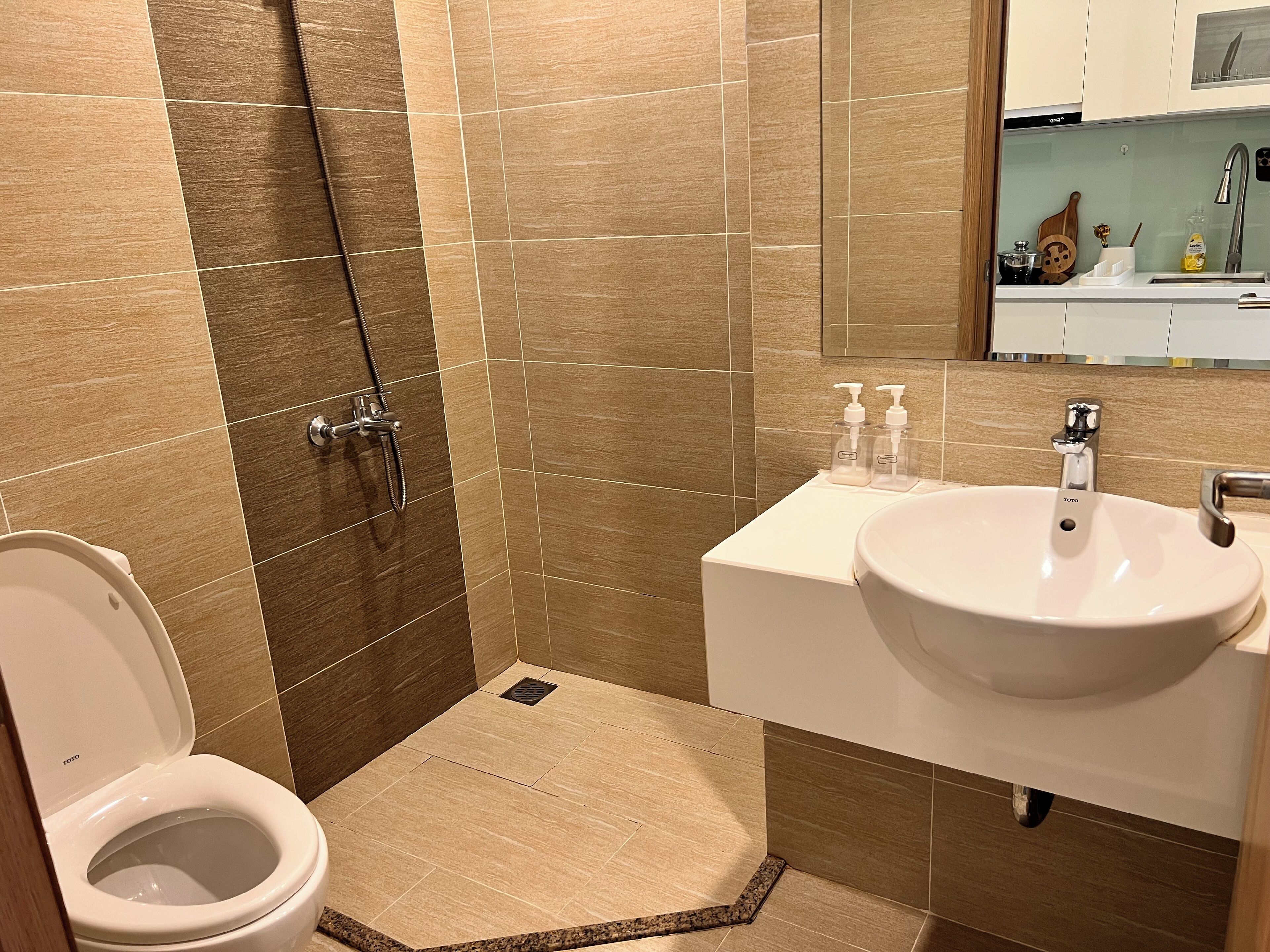 A bathroom with a toilet, sink, and shower.