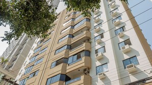 A high-rise building with multiple balconies and air conditioning units. - Cozy 2 Bedroom Apartment in the center of Camboriú, 200 meters from the beach (Centro Balneário Camboriú)