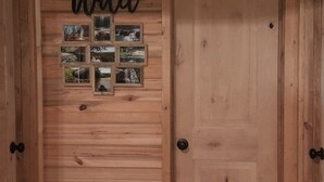 A wooden door with a 'GO wild' sign and a series of framed pictures.