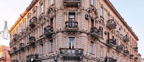 A historic building with ornate facades, multiple balconies, and a central entrance.