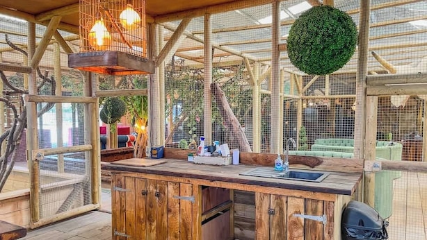 A rustic wooden kitchen with a sink, wooden cabinets, and hanging lights. - Berney Lodge - Puppy Lounge, arcades, games room (Faldingworth)