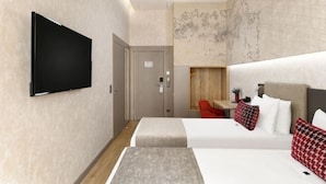A hotel room with a flat-screen TV, a bed with red and white pillows, a small table with a red chair, and a world map on the wall. - Hotel Vision Budapest by Continental Group (Budapest)