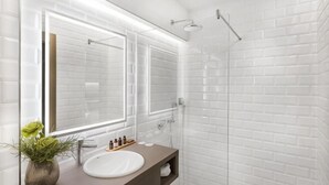A modern bathroom with a white sink, mirror, and shower. - Hotel Vision Budapest by Continental Group (Budapest)