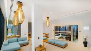 A modern hotel lobby with seating areas, a reception desk, and a glass partition. - Hotel Vision Budapest by Continental Group (Budapest)