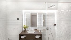 A modern bathroom with white tiled walls, a glass shower enclosure, a wooden vanity with a sink, and a mirror. - Hotel Vision Budapest by Continental Group (Budapest)