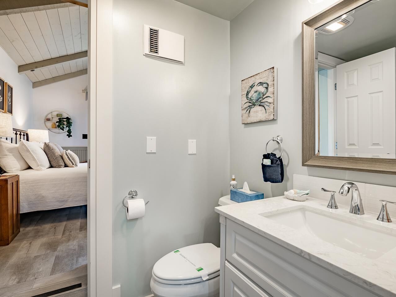 A bathroom with a white sink, a toilet, and a shower area.