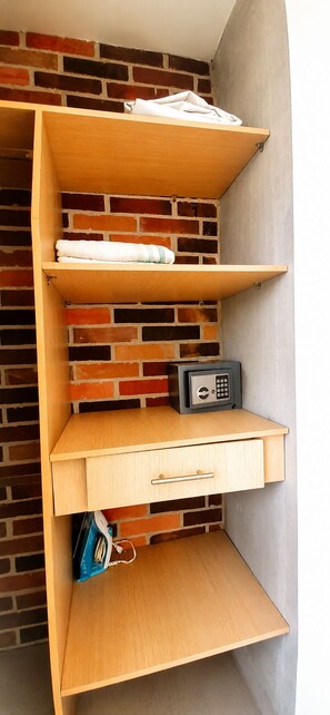 A corner storage unit with shelves and a drawer, against a brick wall. - Mingle with the beautiful Paisas  (Medellín)