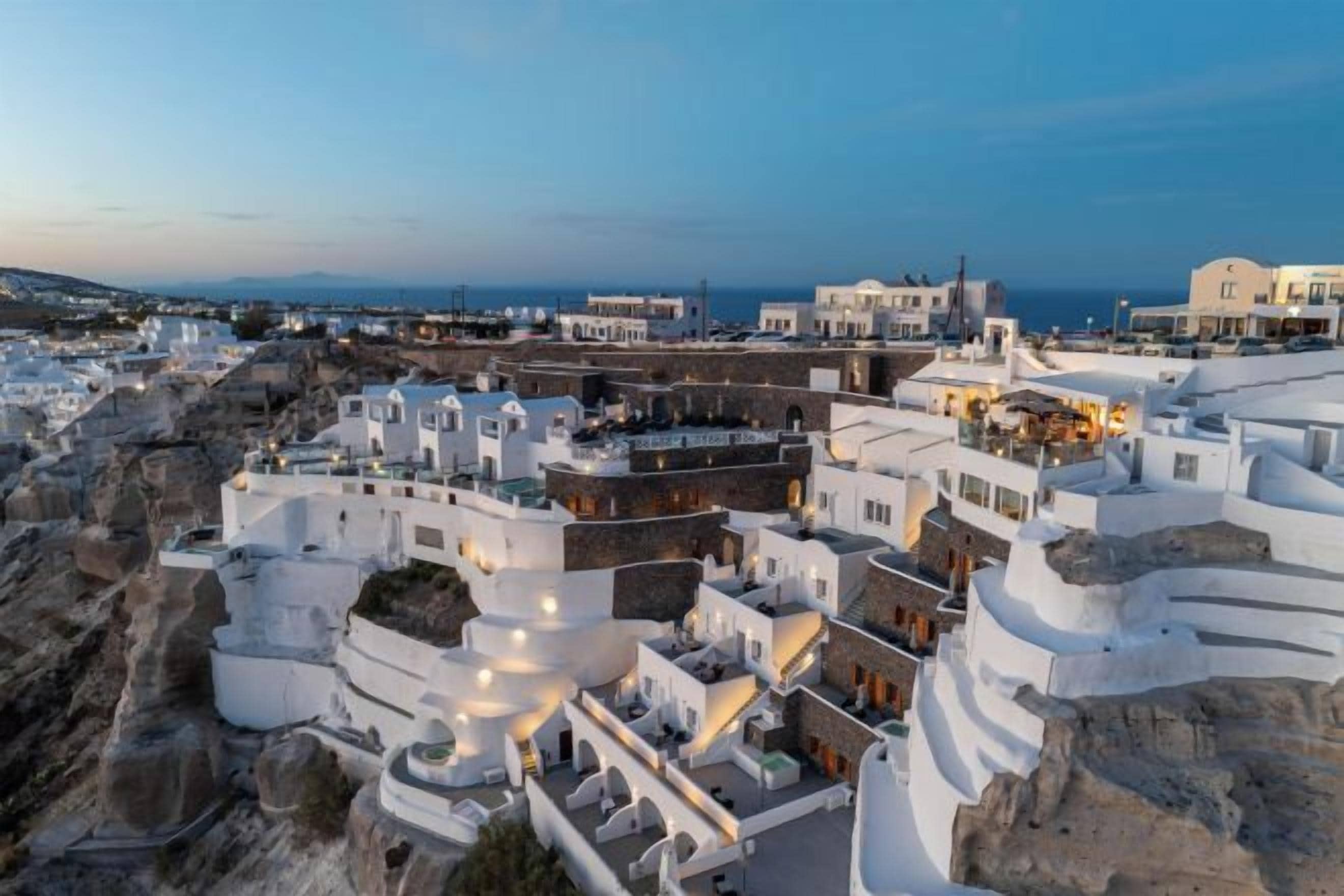 A coastal village with white-washed buildings, narrow streets, and a view of the sea.