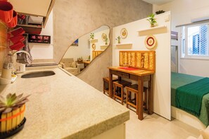 Cozy retreat with a kitchenette, comfortable bed, and functional layout.
