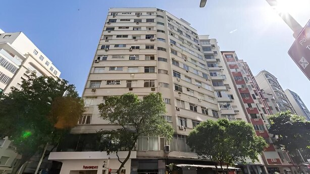 A multi-story building with a flat facade, several balconies, and a clear sky. - SUH Copacabana 79 New Beach (Rio de Janeiro)
