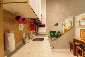 Bathroom features a large mirror, modern sink, and countertop with amenities.