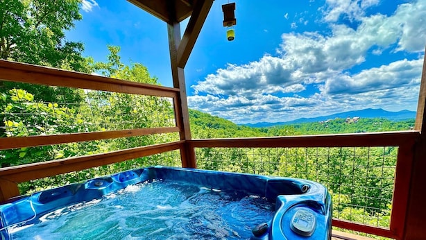 A hot tub on a wooden deck with a scenic view of mountains and trees. - New Amazing View Cabin, 5 miles to Dollywood, 12 miles to Smokies, Sleeps 11 (Sevierville)