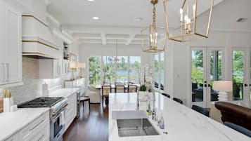 Enjoy meals in the kitchen with a central island, sink, and stove, offering a view of the surrounding landscape.