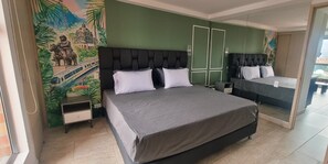 A bedroom with a large bed, a nightstand, a dresser, a mirror, and a mural on the wall. - Cold AC K Fast WiFi Medellin Paradise (Medellín)