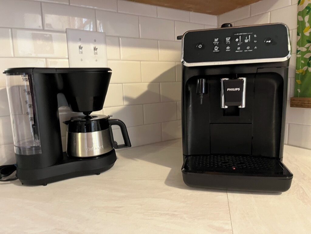 A coffee maker and a water dispenser on a kitchen counter.