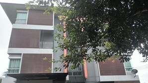 A multi-story building with a modern design, featuring balconies and large windows. - Tonsom Residence (Uttaradit)