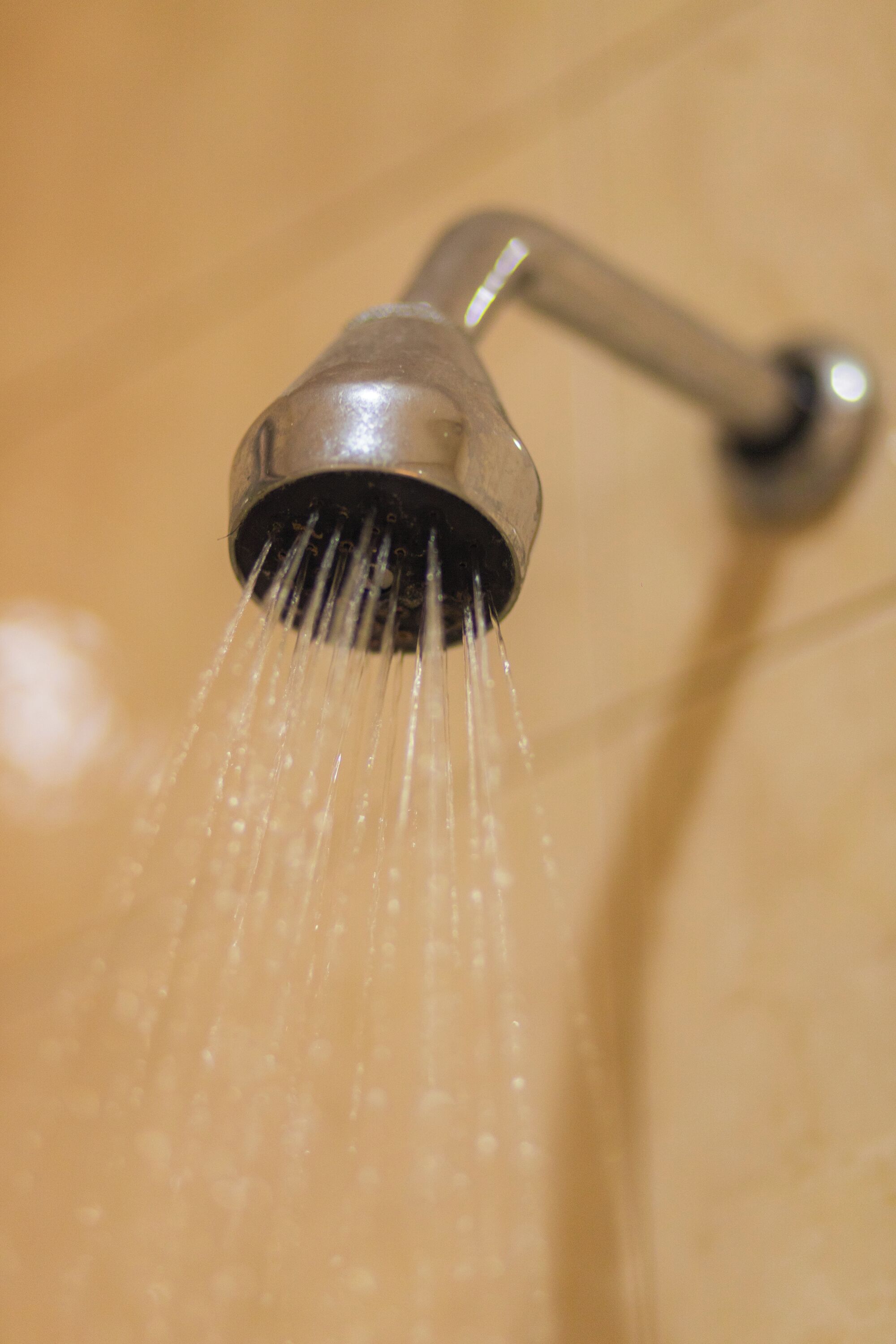 A showerhead with water flowing from it.