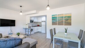 A modern apartment with a living room, dining area, and kitchen. - 'Boliche' Apartment with Shared Pool, Wi-Fi, and Air Conditioning (Alicante (Alacant))