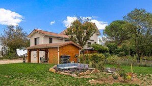 A house with a garden, a swimming pool, and a wooden deck. - Green Room with Private Terrace, Wi-Fi, and Air Conditioning (Chozeau)