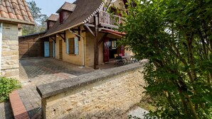 A traditional building with a stone foundation, wooden beams, and a tiled roof.