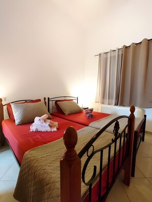 A double bed with a red bedspread, two pillows, and a blanket. - Country House 'Andros - Private Pool' with Sea View, Wi-Fi and Air Conditioning (Andros)