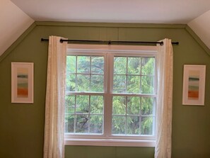 A room with a large window, two framed pictures on the wall, and a curtain rod above the window. - Chimney Hill Charmer for Four Seasons of Fun! (Wilmington)
