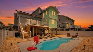 A two-story house with a swimming pool, a covered patio, and a deck. - The Salty Rooster by Brunswick Vacation Rentals: New Pool & Renovated Bedrooms (Ocean Isle Beach)