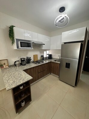 Fridge, microwave, stovetop, coffee/tea maker