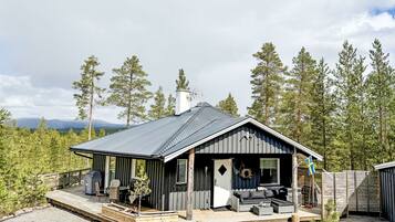 Enjoy the forest views from the spacious deck with outdoor seating and covered porch.