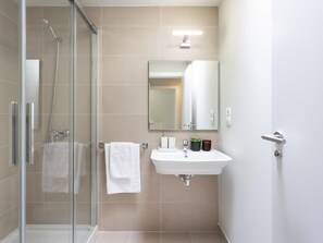 Shower, hair dryer, towels, toilet paper
