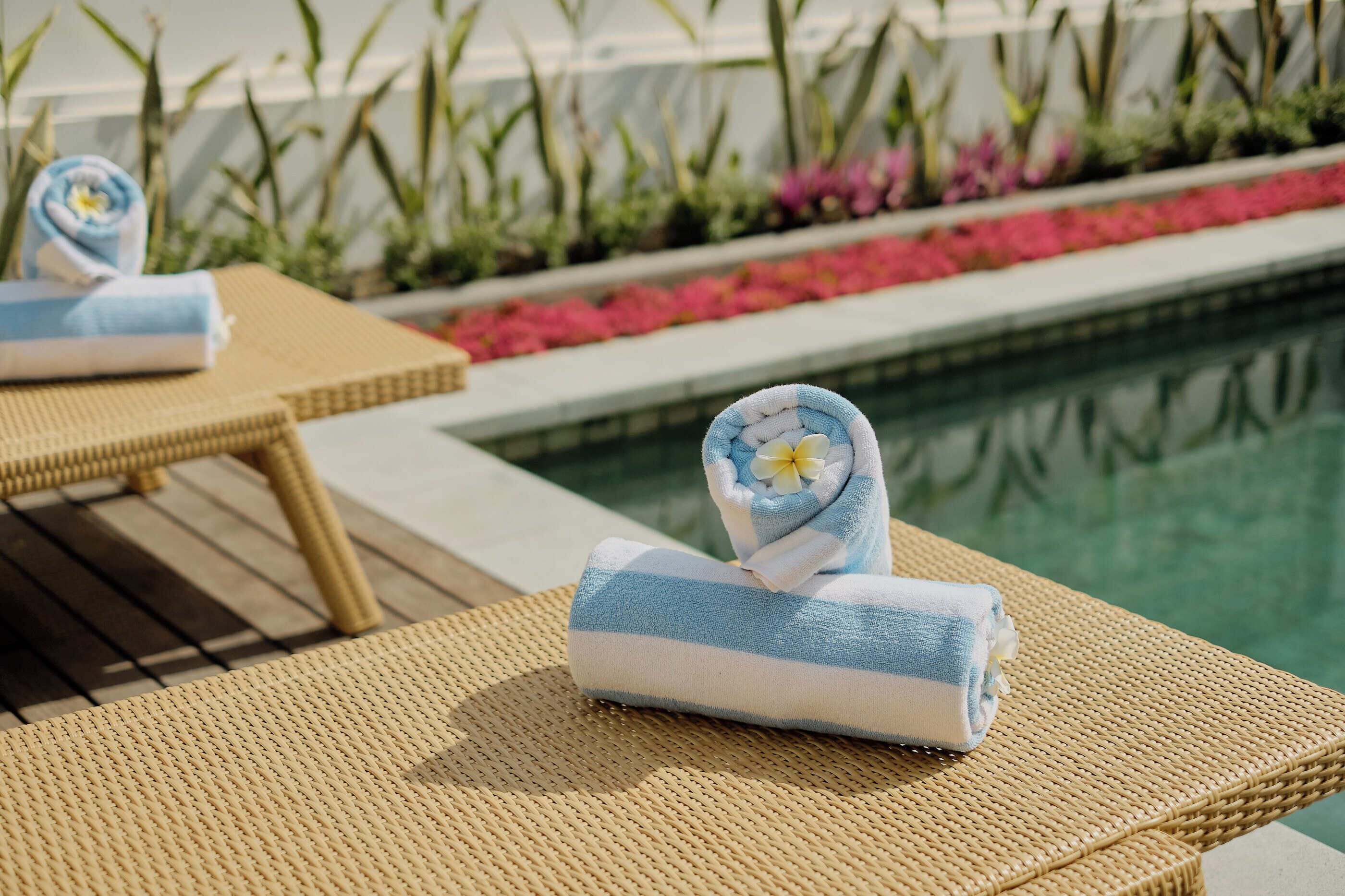 A poolside area with lounge chairs and towels.
