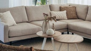 A modern living room with a beige sectional sofa, a round coffee table, and a floor lamp. - Oceanfront 3BR Penthouse | One Mambo 38&39 by Bocobay (Curaçao | Mambo Beach)