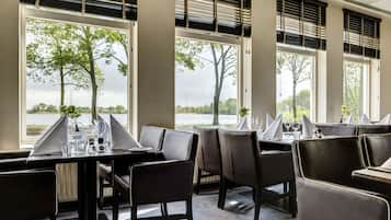 Dine amidst serene views of trees and water from the comfort of this stylish dining area.