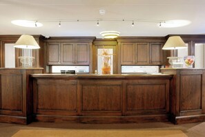 Enjoy cooking in this well-equipped kitchen with a central island, microwave, and stainless steel refrigerator.