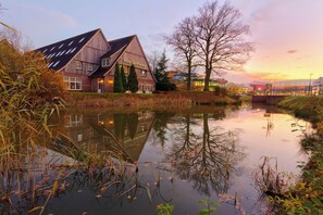 Hotel De Broeerd offers serene views of the surrounding landscape from its traditional building beside a calm river.