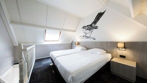 Relax in a spacious room with a large bed, bedside tables, and a unique mural on the ceiling.