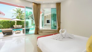 A modern hotel room with a large bed, a glass door leading to a balcony with a pool, and a view of palm trees. - Luxury Pool Villa A14 3BR/8 Persons (Muang Pattaya)