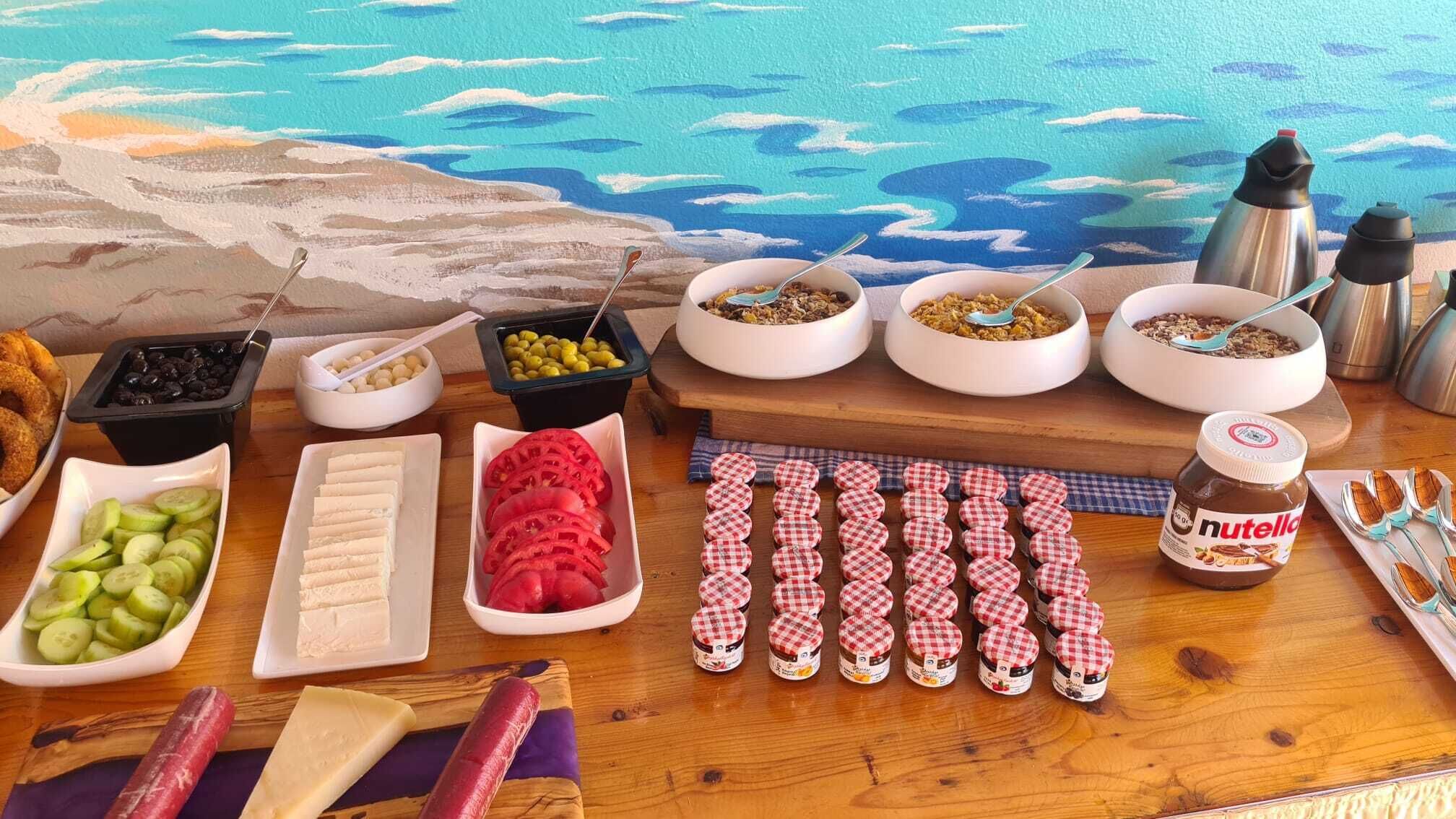 A buffet table with various food items and condiments.