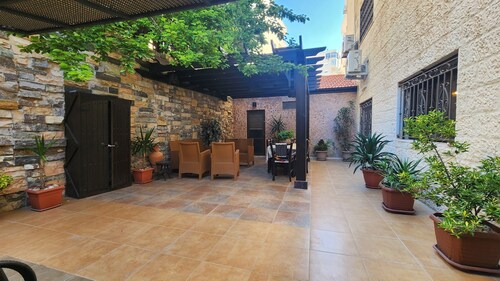 Serene 3-bedroom apartment with AC and garden in charming Amman