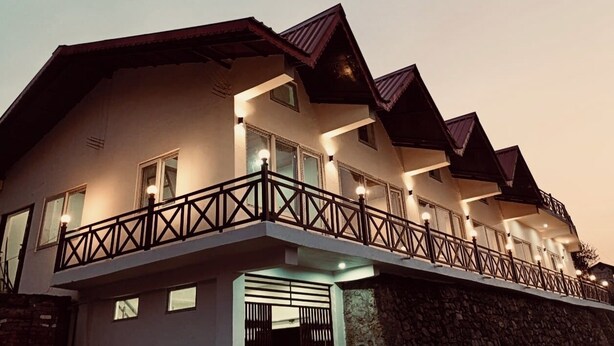 A multi-story building with balconies and a stone foundation. - Harika Palace hidden awayfrom city chaos (Nainital)