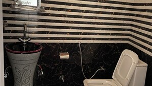 A bathroom with a marble sink, a toilet, and a mirror. - Harika Palace hidden awayfrom city chaos (Nainital)
