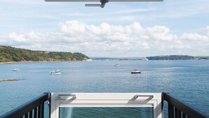 A view from a balcony with a clear sky and several boats on the water. - Cornwall Beachfront Stay | Walk to Pubs & Pasties (Cawsand)