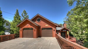 A two-story wooden house with a garage, a covered porch, and a satellite dish. - Large Retreat, Arcade, Lake Access + AC (Lake Arrowhead)