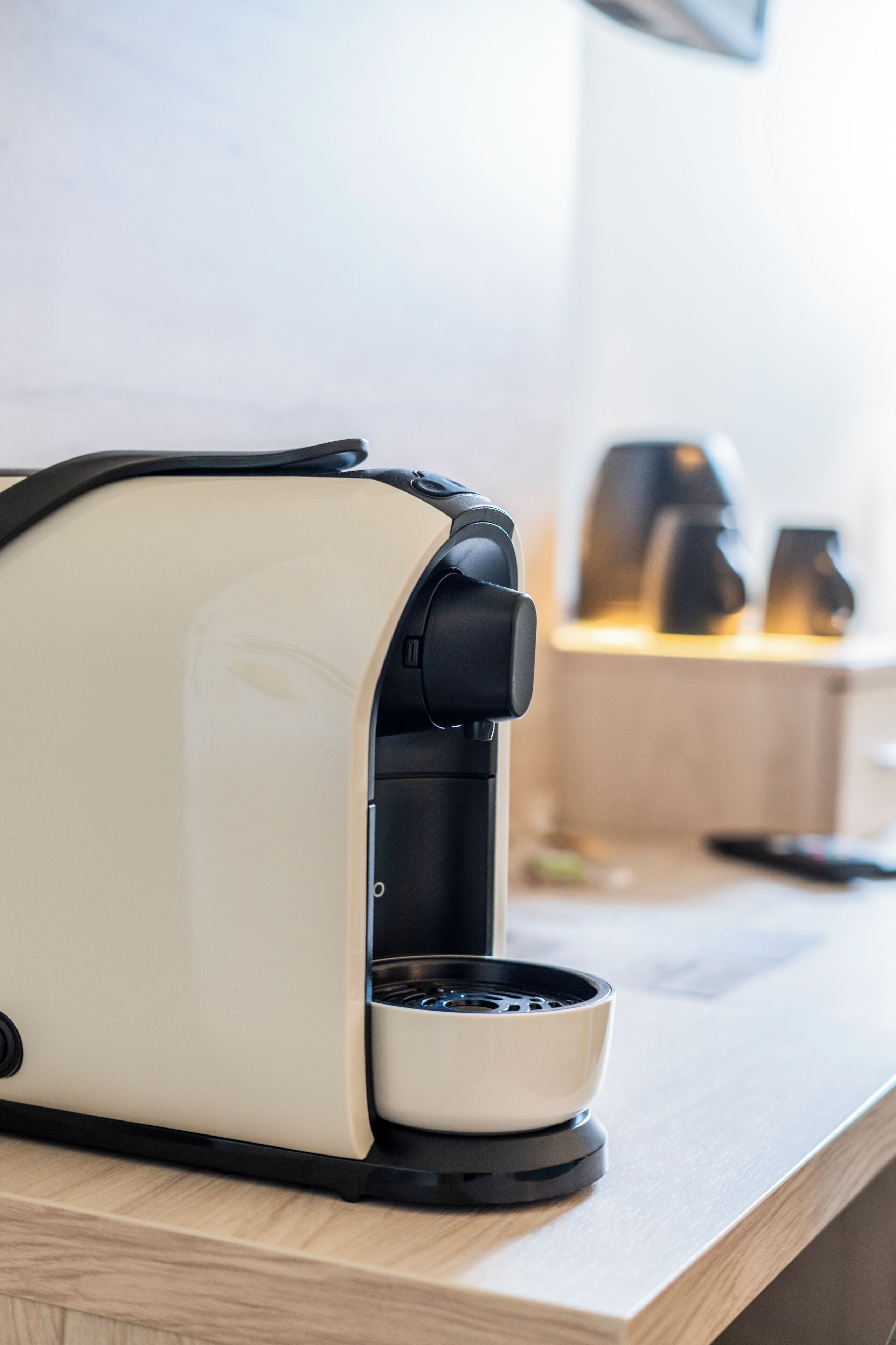 A coffee maker on a countertop with a wooden surface.