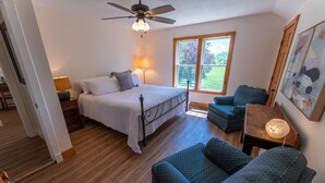 A bedroom with a bed, a desk, a chair, and a window. - Peaceful Pepin Farmhouse Getaway (Pepin)