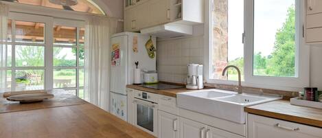 Enjoy cooking in this kitchen with a sink, coffee maker, and refrigerator.