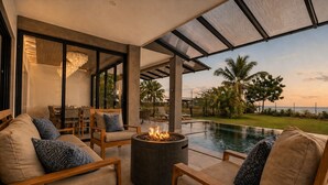 A modern outdoor living area with a pool, fire pit, and seating. - Luxury Beachfront Estate w/ Private Chef, Full Staff/Concierge Resort Amenities (Playa Flamingo)